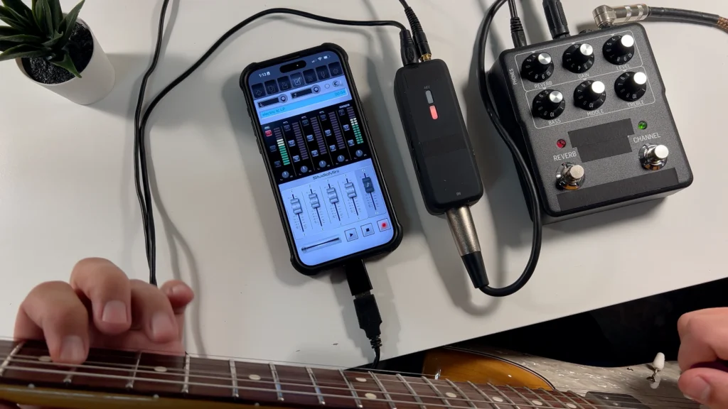 Screenshot of StudioMini on iPhone showing the electric guitar recording setup going direct with an amp simulator and a portable USB audio interface.