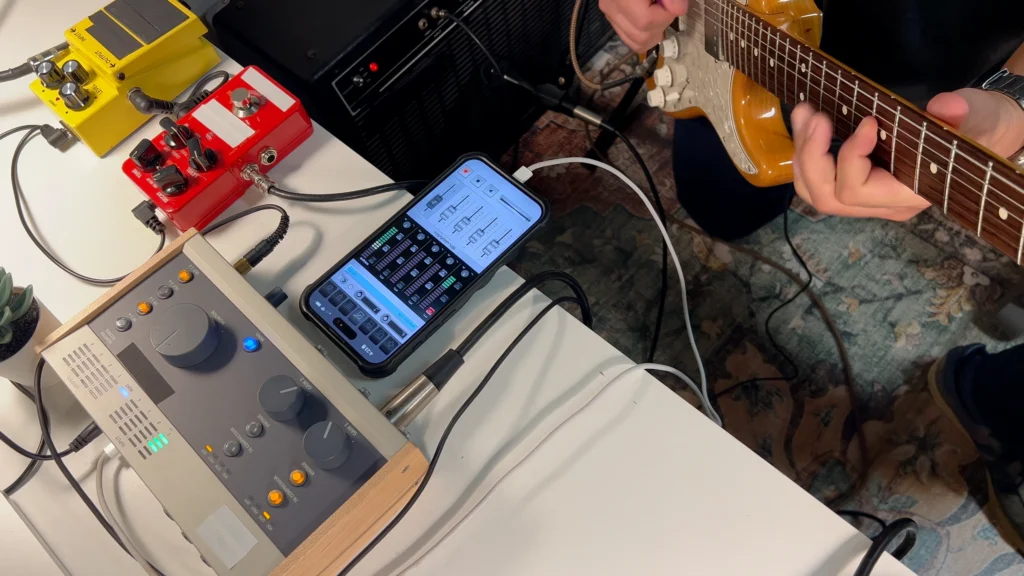 Screenshot of StudioMini on iPhone showing the electric guitar recording setup pedals and mic'd amp going into a USB audio interface.